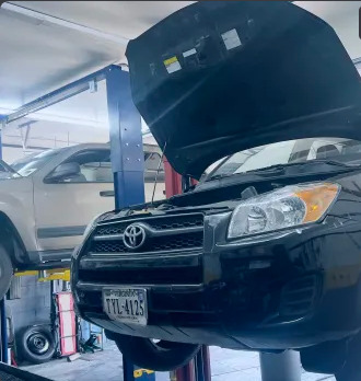 Toyota SUV up on the shop lift mid-service